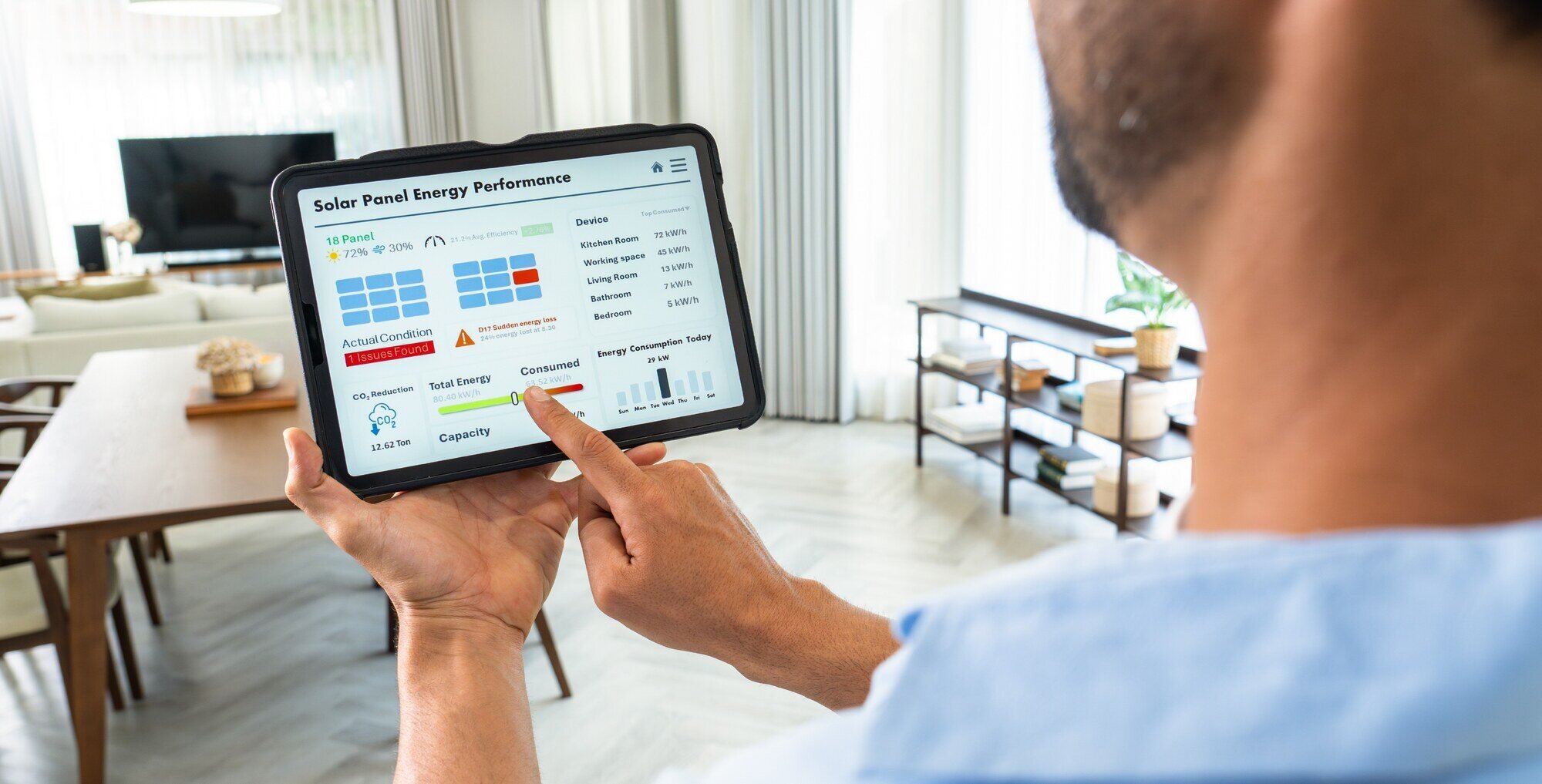 Man reviewing solar production data on tablet